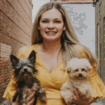 Brittney Burns, professional dog grooming instructor and mentor with paragon pet school, shown holding two small dogs